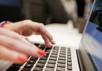 Woman typing Apple MacBook laptop