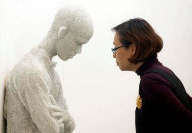 Woman viewing 'Figure with arms crossed' sculpture by Daniel Arsham, Singapore
