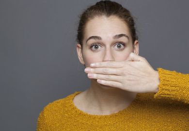 Woman covering her mouth for silence