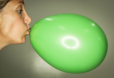 Woman inflating balloon