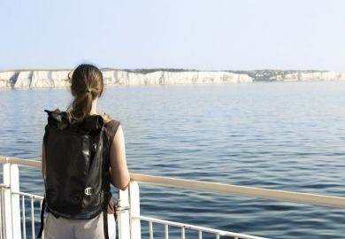 Woman looking out to white cliffs of Dover