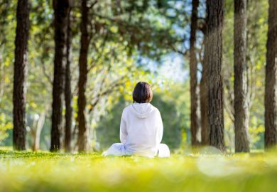 Woman relaxingly practicing meditation Woman relaxingly practicing meditation