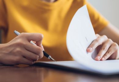 Woman signing document and hand holding pen putting signature at paper