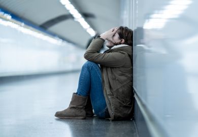 Woman with head in hands