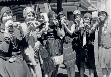 Women eating hot dogs Women eating hot dogs