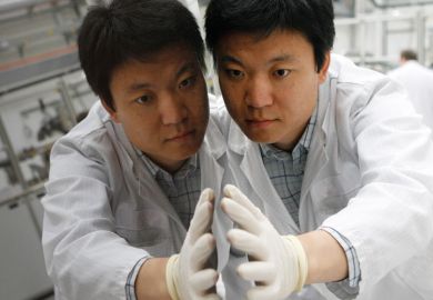 Worker checks thin-film silicon solar module, Truebbach