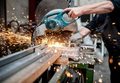 Worker using a sliding compound mitre saw Worker using a sliding compound mitre saw