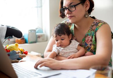 Working mum with baby in lap