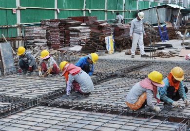 Workmen working on building foundations