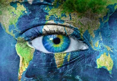 Planet earth painted around a human eye, illustrating international vision