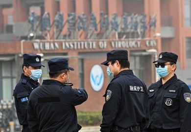 Security personnel stand guard outside the Wuhan Institute of Virology as members of the World Health Organization team investigating the origins of Covid-19 visit the institute