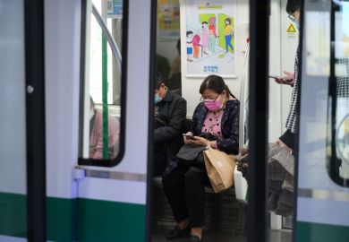 Wuhan China-Oct 2020 passengers in face mask to prevent coronavirus, sitting inside subway train in Wuhan
