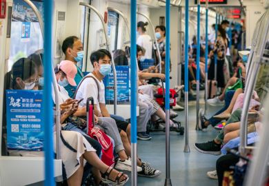 Wuhan China , 29 August 2020 Chinese people wearing surgical face masks inside the Wuhan subway carriage in Wuhan Hubei China