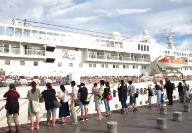 Yokohama, Japan - August 16th, 2018 People celebrating the departure of cruise ship Pacific Venus at the Osanbashi Pier in Yokohama.