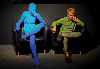 Young boy imitating Lego sculpture