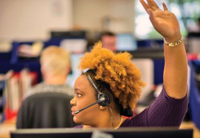 Young female student raising hand to ask question