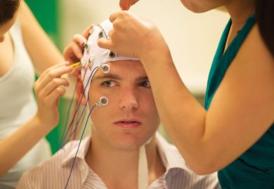 Young man being prepared for brain experiment