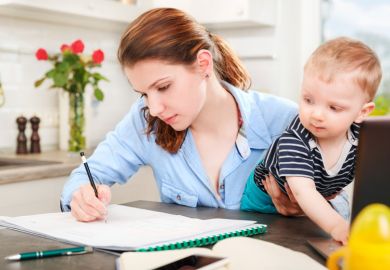 Young mother studying at home with baby Young mother studying at home with baby