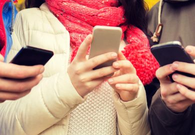 Young people gathered together using smartphones Young people gathered together using smartphones