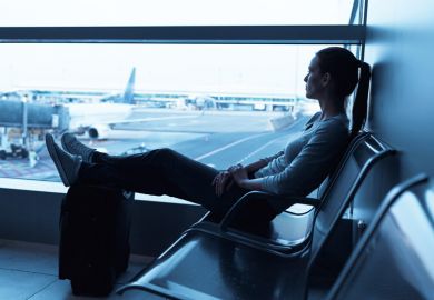 Young woman seated in airport departure lounge Young woman seated in airport departure lounge
