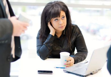 Young woman seated in front of laptop computer