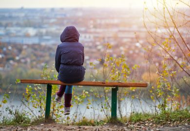 Young woman sitting on bench