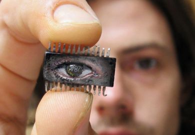 Yuri Zupancic holding microchip painting