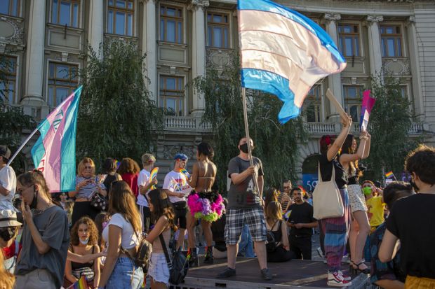14.08.2021 Romania - Bucharest. A transsexual waving the trans pride flag on the stage set up at the University, at the lgbt pride parade.