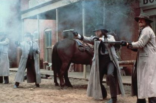 Gunslingers/cowboys fire their guns Gunslingers/cowboys fire their guns