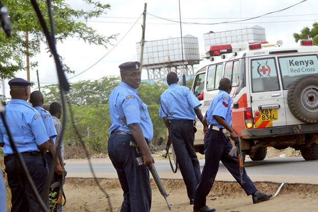 Kenyan police officers take positions outside Garissa University College Kenyan police officers take positions outside Garissa University College