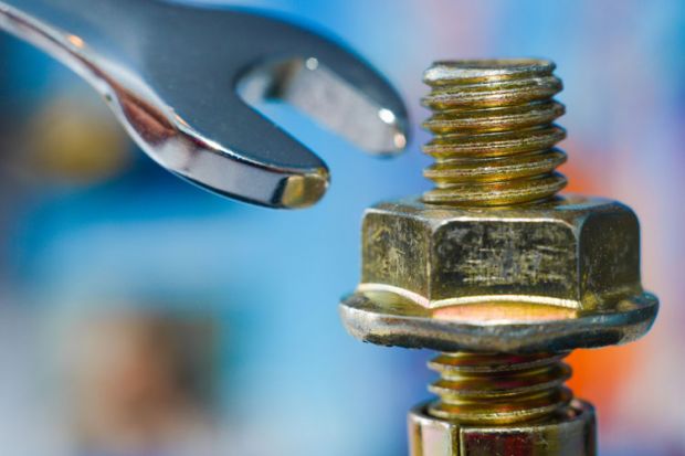 Spanner being used to tighten a nut