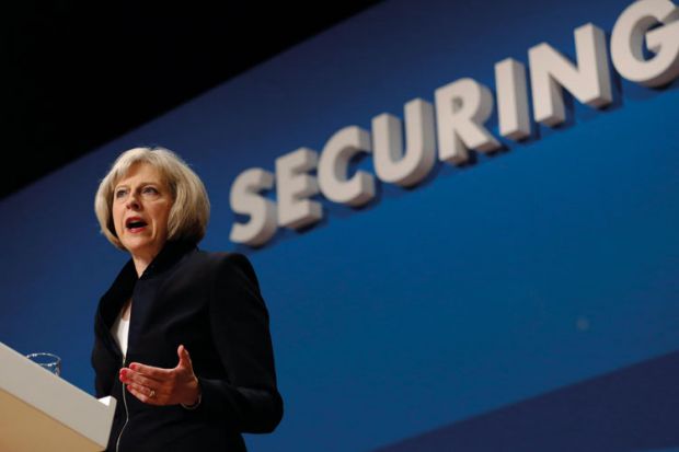 Theresa May speaking at podium