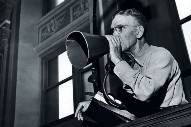 A man using a meaphone A man using a meaphone