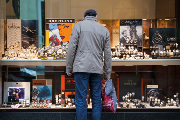 Window shopper looking at luxury watches