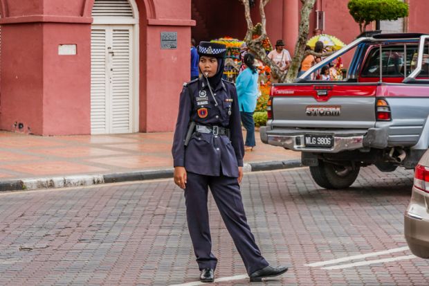 A traffic policewoman wearing hijab at duties, Malacca, Malaysia
