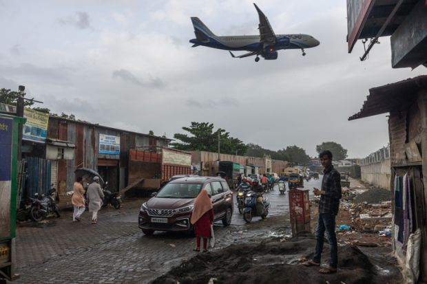 An aeroplane flies over slums in Mumbai An aeroplane flies over slums in Mumbai