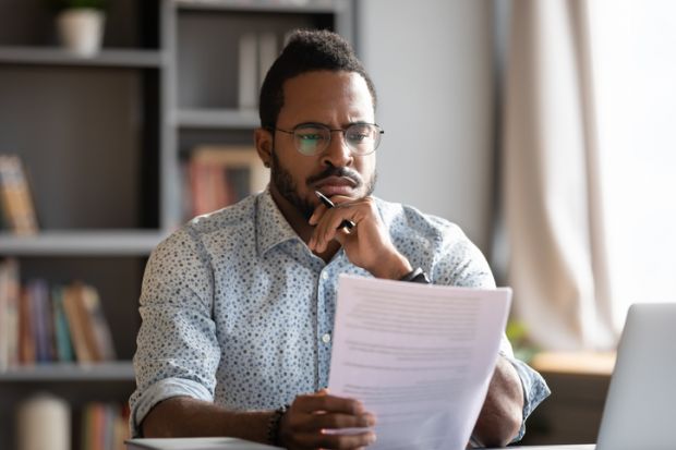 An African academic reads a thesis An African academic reads a thesis