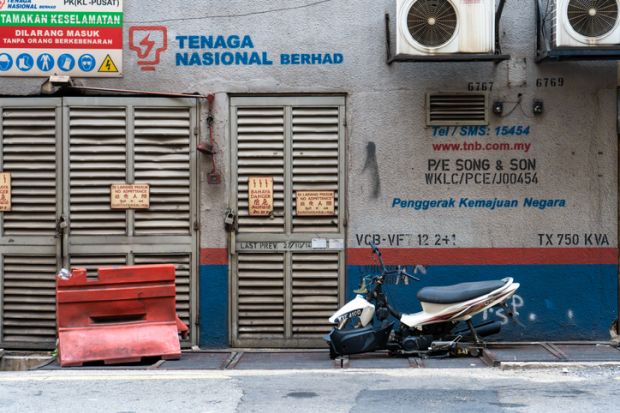 An abandoned semi-dismantled bike on a city street. Kuala Lumpur  Malaysia