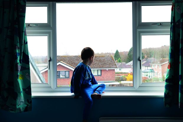 Kid sitting at window