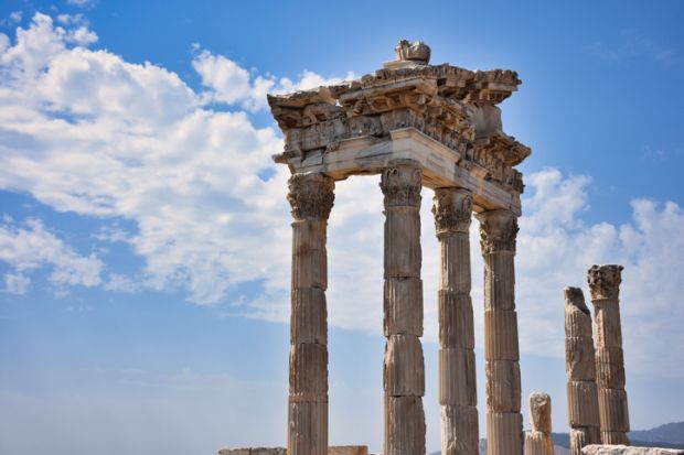 Archaeological structures, ancient columns and sites with nice clear sky. Temple of Trajan in the ancient city of Pergamon, Bergama, Turkey