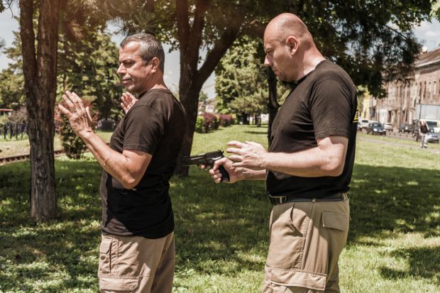 A man being held at gun point