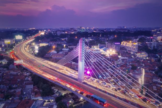 Aerial view of glowing Pasupati overpass at evening in Bandung city  Aerial view of glowing Pasupati overpass at evening in Bandung city