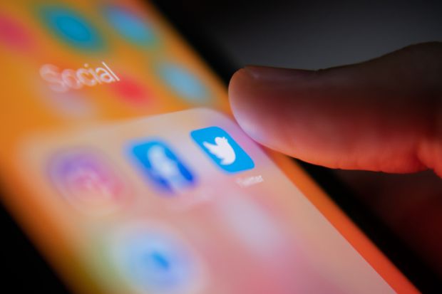 Bangkok, Thailand - July 14, 2019  iPhone user touching Twitter logo on iPhone screen to open the app.