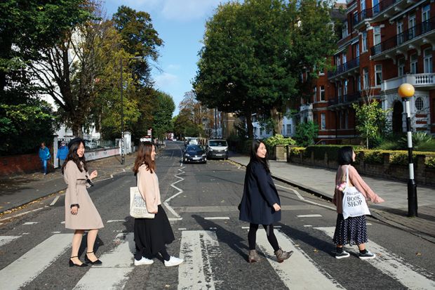 Chinese tourists walk across Abby Road in London, England, recreating the famous 1969 Beatles 'Abby Road' album cover photograph Chinese women walk across Abbey Road, London to illustrate Chinese women ‘see study as an escape’