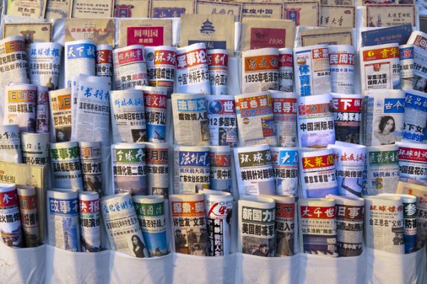 Beijing, China - March 12, 2012 Chinese newspapers in a newsstand