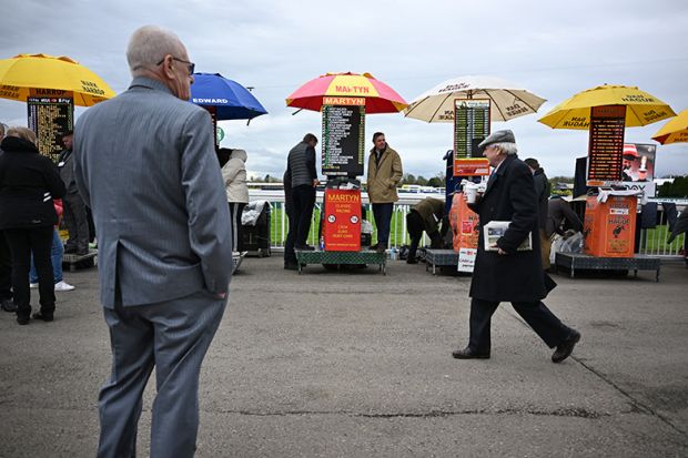 Racegoers walk past bookmakers' betting stands on the final day of the Grand National Festival horse race meeting, illustrating the low success rates for some UK research council grant schemes. Racegoers walk past bookmakers' betting stands on the final day of the Grand National Festival horse race meeting, illustrating the low success rates for some UK research council grant schemes.