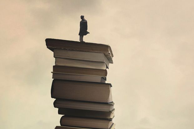 Person standing on tower of books Person standing on tower of books