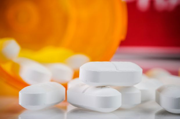 Bottle of pills spilled on surface Bottle of pills spilled on surface