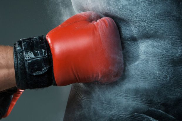 Boxer's hand punching heavy bag Boxer's hand punching heavy bag
