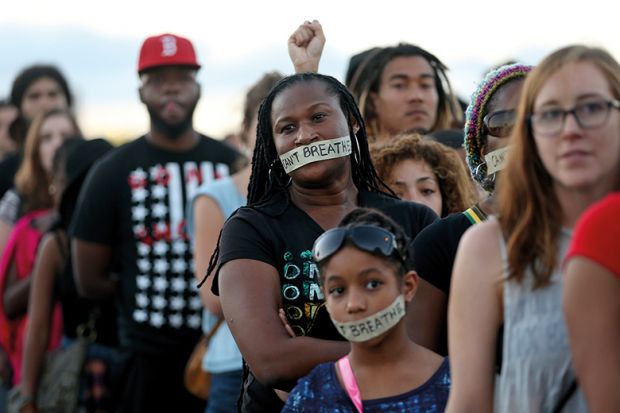 Demonstrators stand with tape reading: “ I can’t breathe” to protest police abuse Demonstrators stand with tape reading: “ I can’t breathe” to protest police abuse on December 7, 2014 in Miami, Florida.